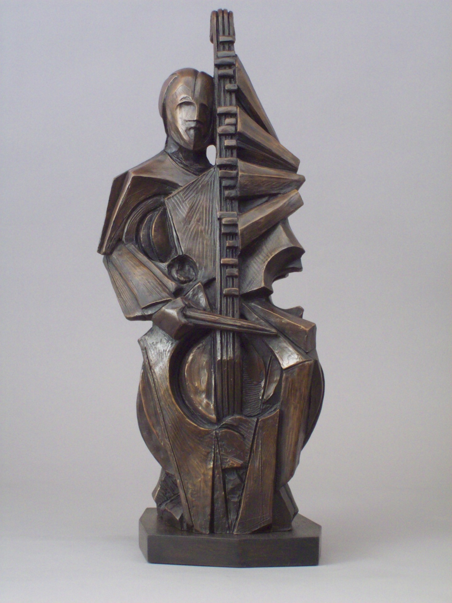 Bronze statue of person playing instrument